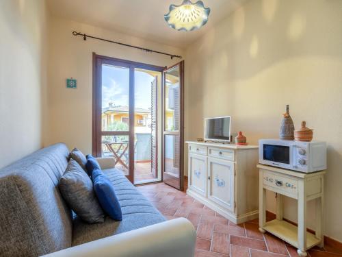 a living room with a couch and a microwave at Apartment Del Colle by Interhome in Viddalba