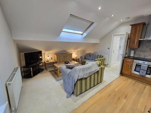 a kitchen and living room with a skylight at Cosy 2 Bedroom Apartment With Free Parking in Sheffield