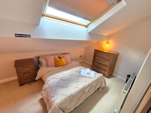 a bedroom with a bed and a skylight at Cosy 2 Bedroom Apartment With Free Parking in Sheffield