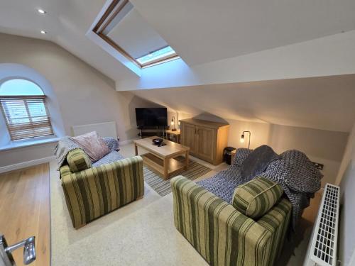 a living room with two couches and a tv at Cosy 2 Bedroom Apartment With Free Parking in Sheffield
