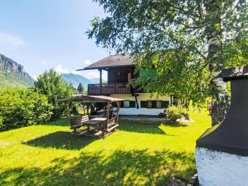 a house with a picnic table in the grass at Chalet Altavista by Interhome in Ziano di Fiemme