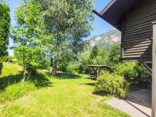 a yard with a gazebo next to a house at Chalet Altavista by Interhome in Ziano di Fiemme