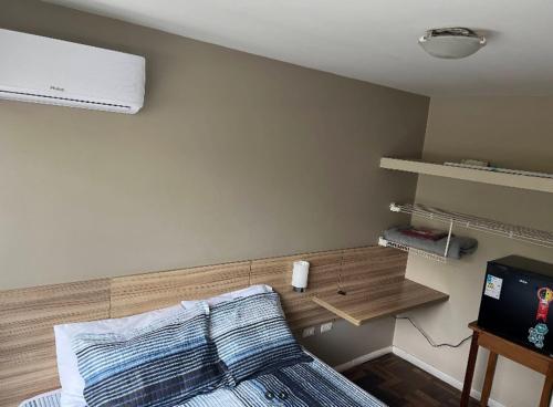 a bedroom with a bed and a television in it at Vicz Palace Hotel in Curitiba