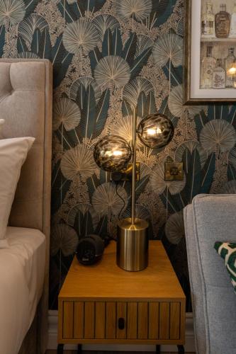 a lamp on a table next to a bed at No 5 Rose Inn Street - Room 3 in Kilkenny