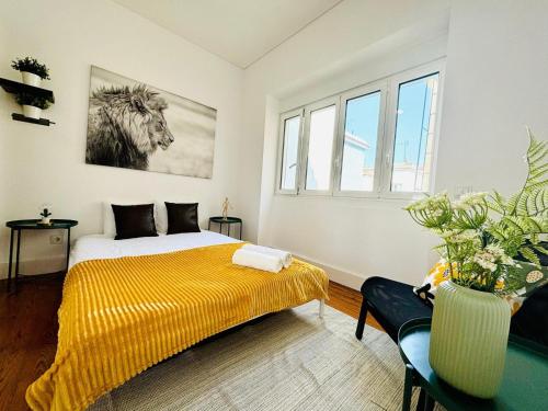 a bedroom with a bed with a yellow blanket at Luxury rooms, Lisbon city centre in Lisbon