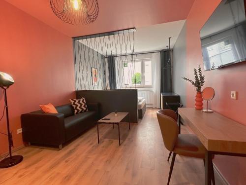 a living room with a couch and a table at CASE Living Marl in Marl