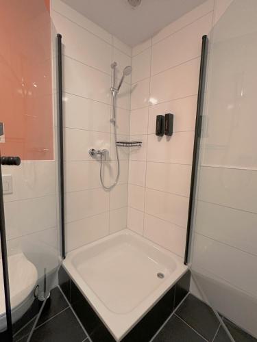 a bathroom with a shower and a toilet at CASE Living Marl in Marl