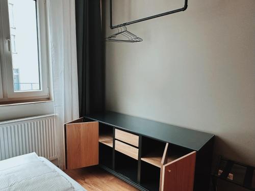 a bedroom with a black desk and a bed at CASE Living Marl in Marl