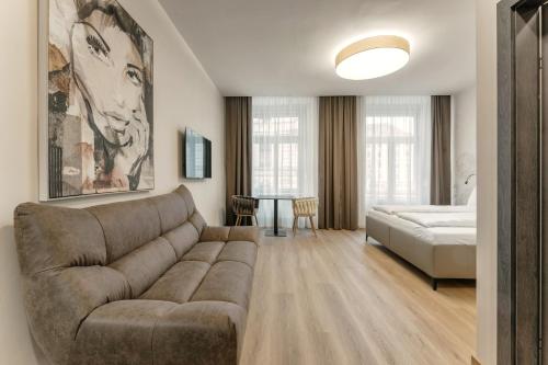 a living room with a couch and a bed at Aparthotel Lavilo Main Square in Graz