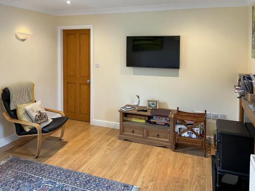 a living room with a flat screen tv on the wall at River View Pateley - Uk47337 in Pateley Bridge