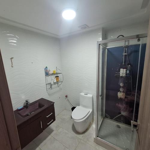 a bathroom with a shower and a toilet and a sink at Appartement marbella beach in Mansouria