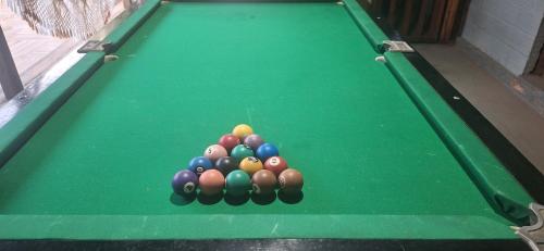 a group of balls on top of a pool table at Espaço Sairé - 8 minutos da Praia in Alter do Chao