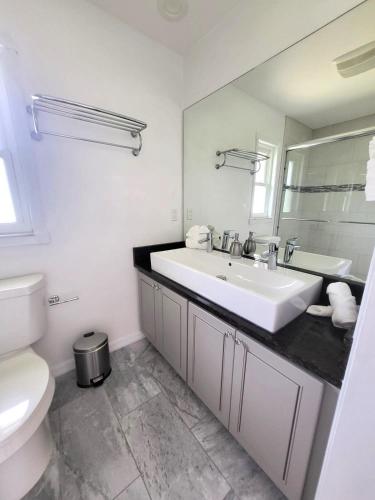 a white bathroom with a sink and a toilet at Emerald House in Bradenton