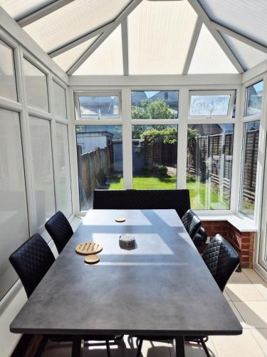 a dining room with a large table and chairs at Bellavita brand new room in Canley