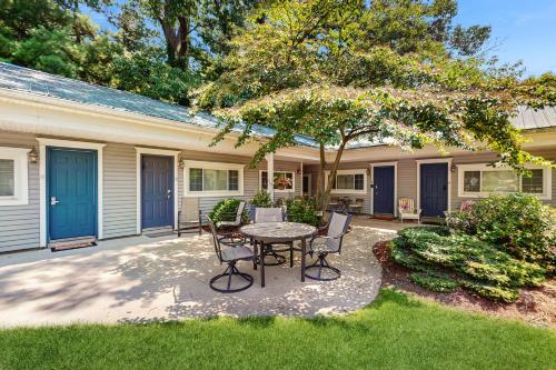 a patio with a table and chairs in front of a house at Arrowhead Resort in Saugatuck