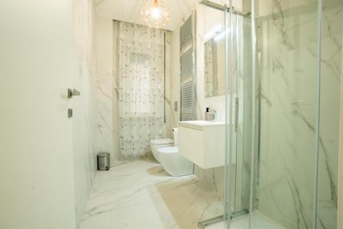 a bathroom with a toilet and a glass shower at Domus Aurea in Termoli