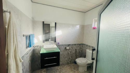 a bathroom with a sink and a toilet at Zilwest Villa in Flic-en-Flac