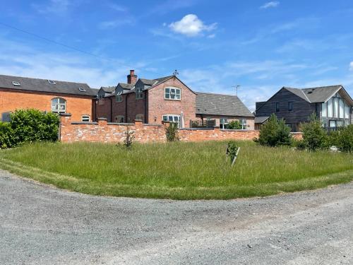 a field of grass in front of a house at Grooms Cottage in Leicester