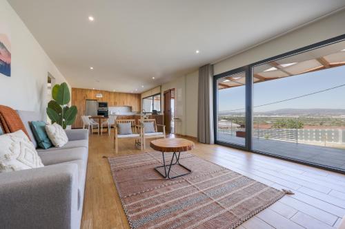 a living room with a couch and a table at Casas do Picoto in Chaves