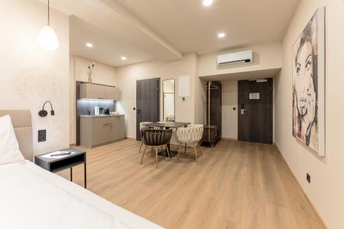 a room with a bed and a table and chairs at Aparthotel Lavilo Main Square in Graz