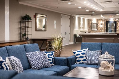 a blue couch with pillows on a table in a room at Holiday Inn Manahawkin/Long Beach Island by IHG in Manahawkin