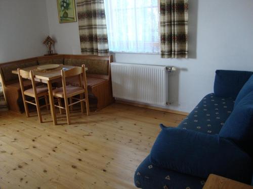 a living room with a table and a couch at Graglerhof in Liebenfels