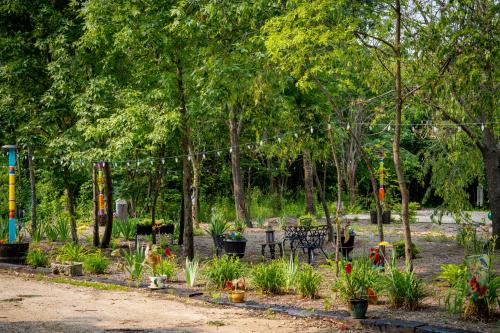 a garden with plants and trees with at Hermann Grain Bins Chicken Run grain bin sleeps 8 in Hermann