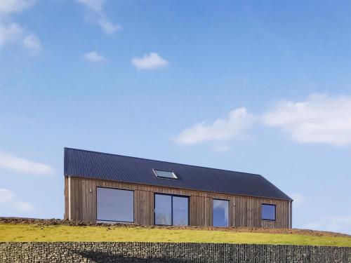 a wooden house on top of a hill at Faodail in Portree