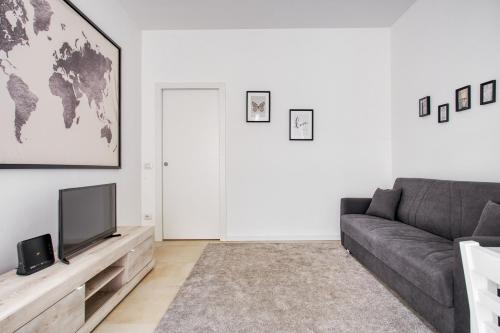 a living room with a couch and a television at New and bright flat close to Navigli area - Cermenate B4 in Milan