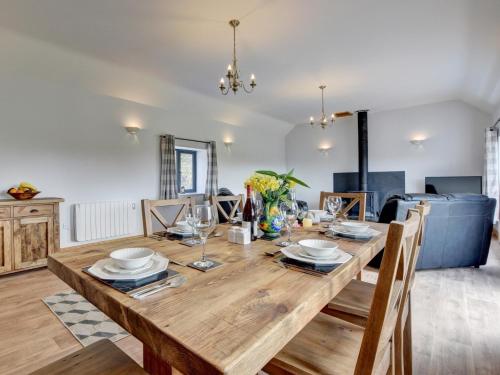 a dining room with a wooden table and chairs at 2 Bed in South Molton 88993 in Bishops Nympton