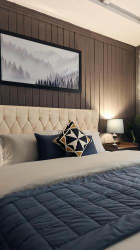 a bedroom with a large bed with a large headboard at Soma Hotels Skardu in Skardu