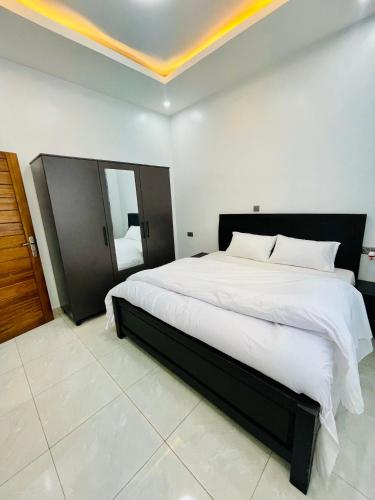 a bedroom with a large bed in a room at The Luxe Urban Lounge in Kigali