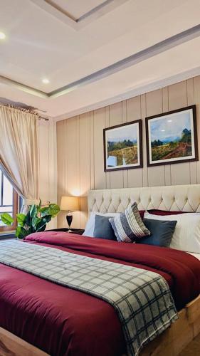 a bedroom with a large bed with a red blanket at Soma Hotels Skardu in Skardu