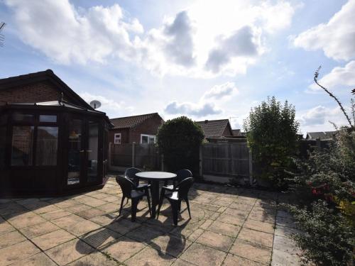 a patio with a table and chairs in a backyard at 2 bed in Sutton-on-Sea 80703 in Sutton on Sea