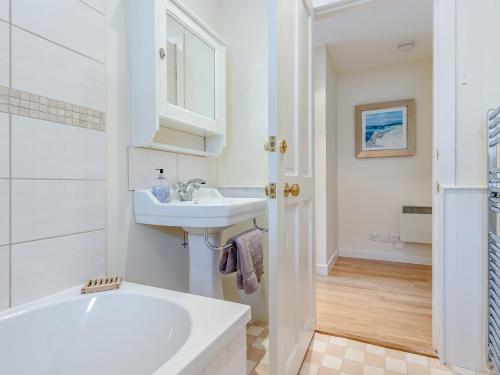 a white bathroom with a sink and a bath tub at 1 Bed in Blacklunans CA361 in Cray