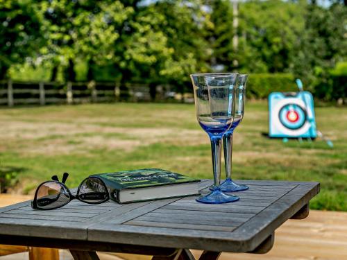 a table with a wine glass and a book at 2 Bed in Hailsham 89416 in Hailsham
