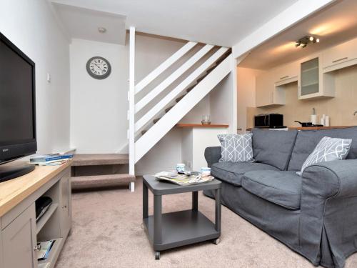 a living room with a couch and a staircase at 1 Bed in Saltburn-by- the- Sea 75726 in Marske-by-the-Sea