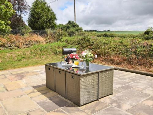 an island on a patio with flowers on it at 5 Bed in Newquay 46489 in Truro