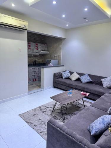 a living room with a couch and a table at المحرق للشقق المخدومة in Al Hofuf