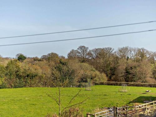 a green field with a fence and animals in it at 2 Bed in Ludlow CHL38 in Caynham