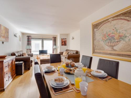 a dining room and living room with a table and chairs at 2 Bed in Fort Augustus 80700 in Fort Augustus