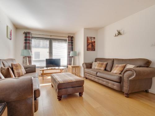 a living room with two couches and a tv at 2 Bed in Fort Augustus 80700 in Fort Augustus