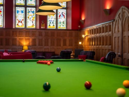 a pool table with balls in a room with stained glass at 2 Bed in Fort Augustus 80700 in Fort Augustus