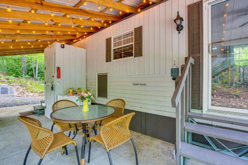 a patio with a table and chairs on a porch at Hike, Swim, Ski and More Pet-Friendly Newland Home! in Newland