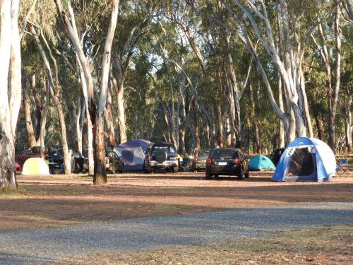 a tent is set up in the middle of a parking lot at Victoria Lake Holiday Park in Shepparton