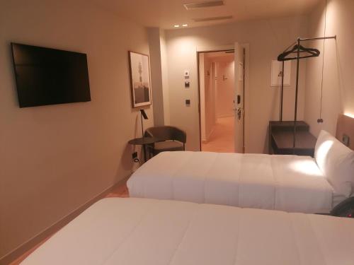 Postel nebo postele na pokoji v ubytování U-Hotel Aduana Ribadeo