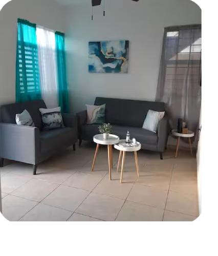 a living room with a couch and a table at Atlantic View Apartments in Hatillo