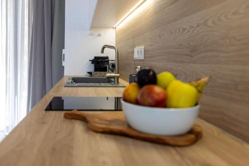 a bowl of fruit on a counter in a kitchen at Bonsai Luxury Villas Naxos in Naxos Chora