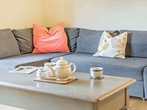 a living room with a blue couch and a coffee table at 1 bed in Bampton LIMKC in Bampton