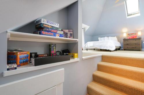 a room with a staircase with a bed and books at Home with Garage, Hot Tub, near OSU & Short North in Columbus